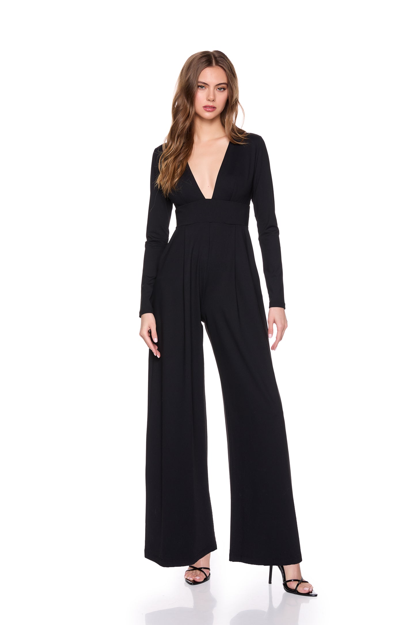 A woman wearing the Susana Monaco Very V Long Sleeve Jumpsuit