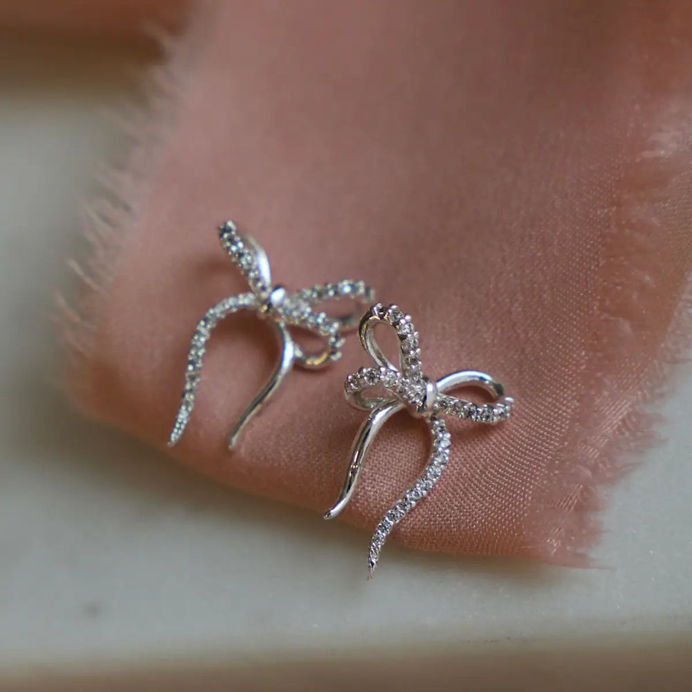 
                      
                        Find the Silver CZ Bow Studs by Katie Waltman Jewelry at Harbour Thread!
                      
                    