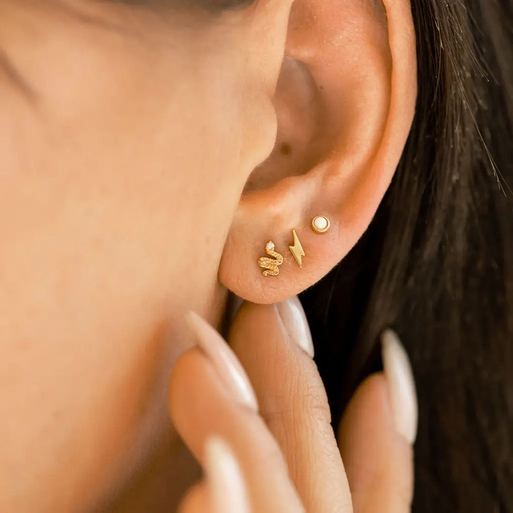 
                      
                        Lightning Stud Earrings in Gold by The Land Of Salt
                      
                    