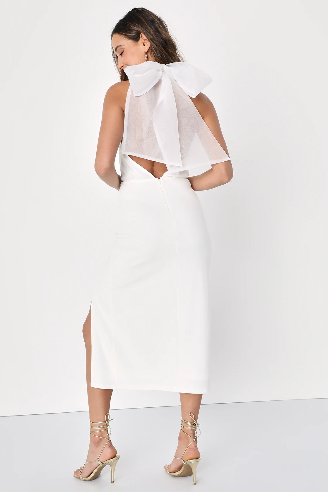 Back view of a woman wearing a White Organza Halter Bodycon Midi Dress