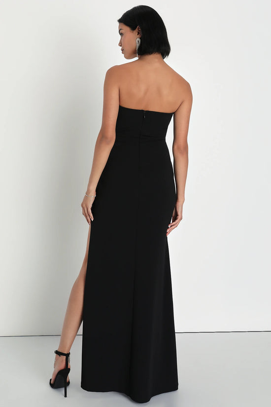 Back view of a woman wearing a Black Pleated Strapless Bustier Maxi Dress by LuLu's