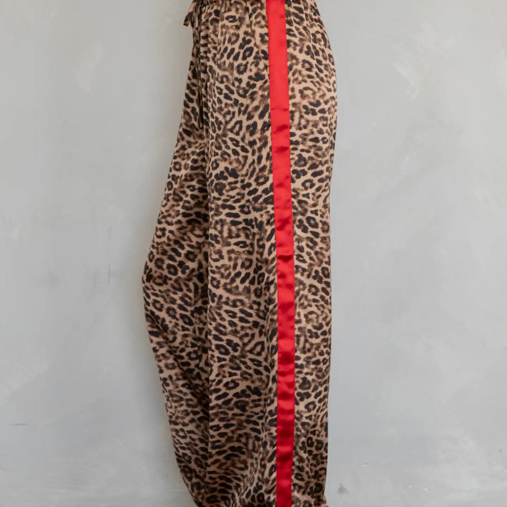 Women's leopard print pants with a red stripe on the side