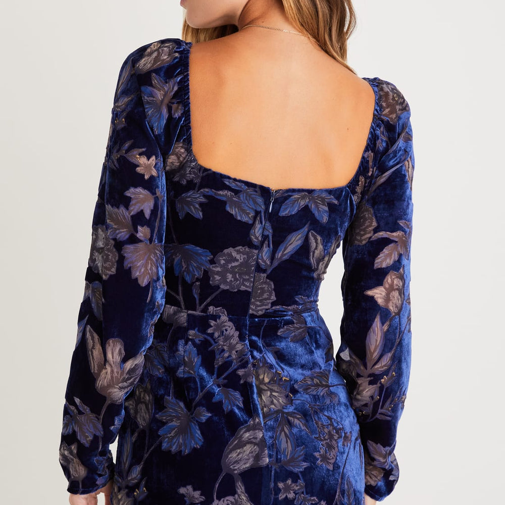 Back view of a woman wearing a Navy Floral Velvet Burnout Bustier Mini Dress by Lulus