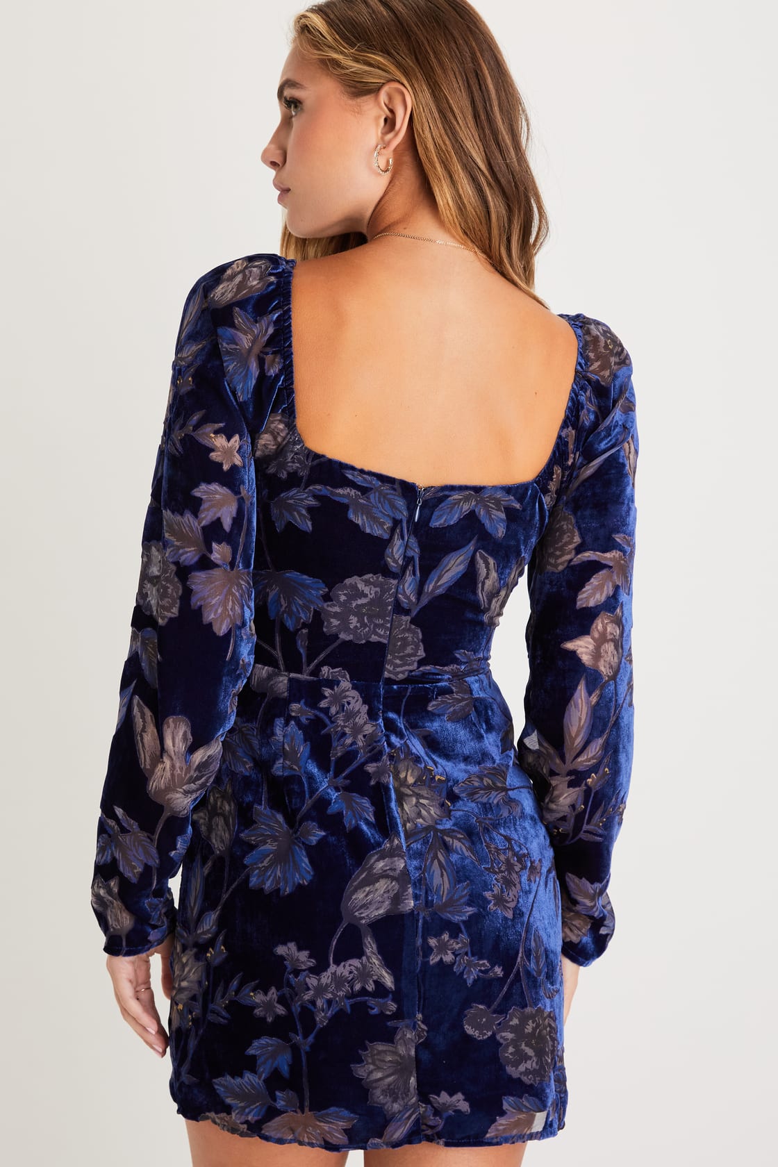 Back view of a woman wearing a Navy Floral Velvet Burnout Bustier Mini Dress by Lulus