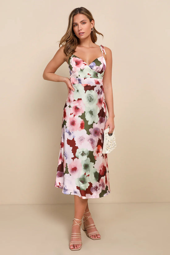 Front view of woman wearing a floral midi dress with a-line silhouette and tie straps