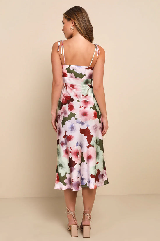 Back view of woman wearing a floral midi dress with a-line silhouette and tie straps