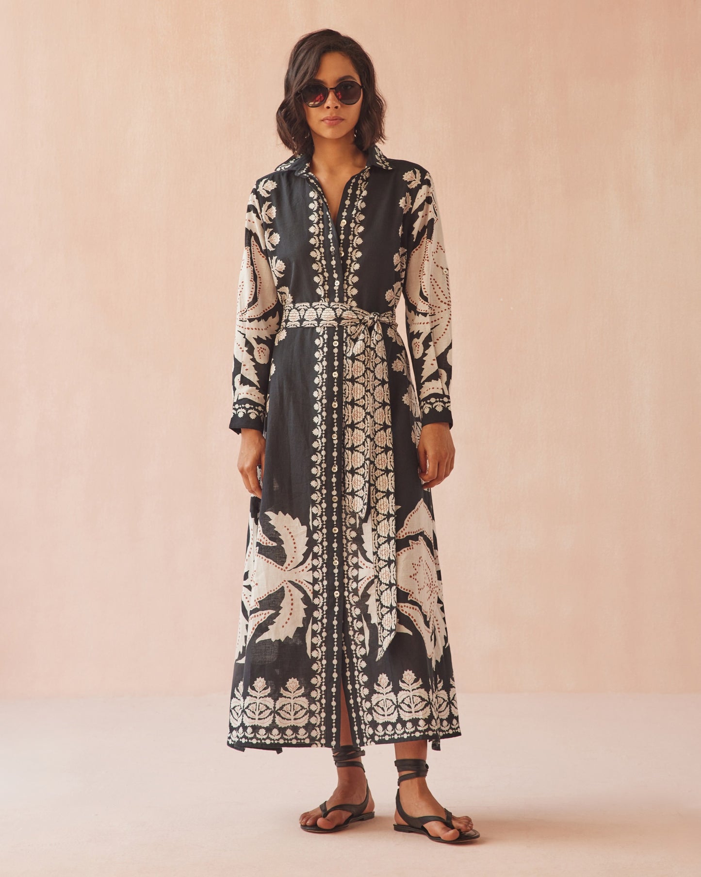A woman wearing the Emma belted maxi shirt dress by OMIKA