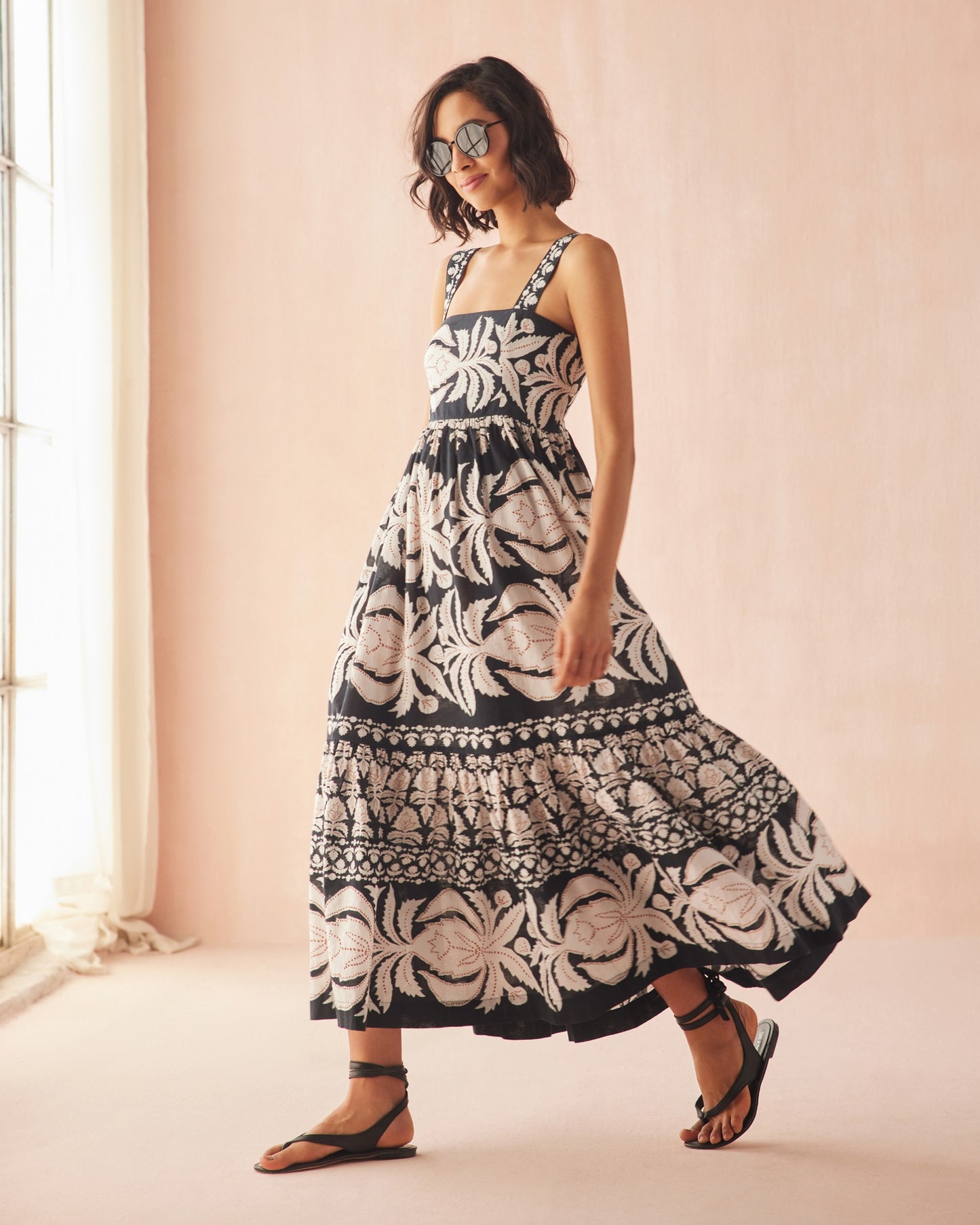 Woman wearing a patterned maxi dress from OMIKA