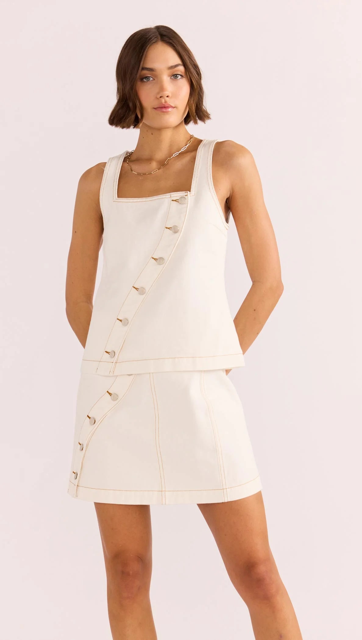 Find the white denim Tabitha Wave Button Mini Skirt by MINKPINK at Harbour Thread