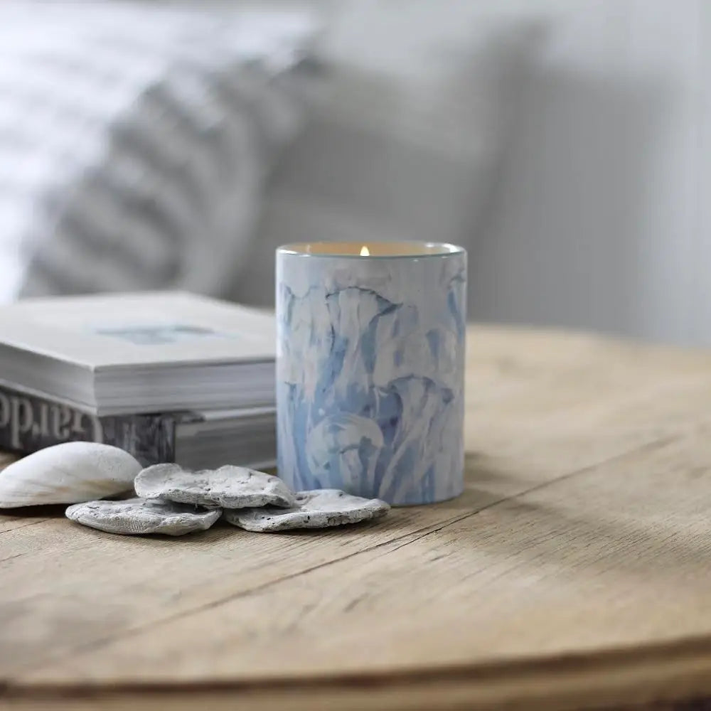 
                      
                        The Ethereal Coast 15 oz Ceramic Candle by Annapolis Candle on a table
                      
                    