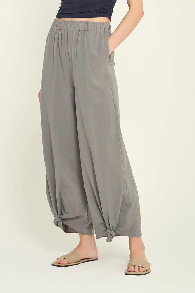 
                      
                        front view of woman wearing grey knotted hem pants
                      
                    