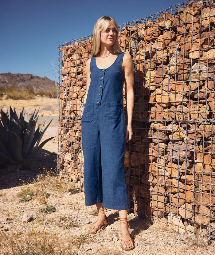 Woman outside wearing Marine Layer's Sydney Jumpsuit in the color Indigo