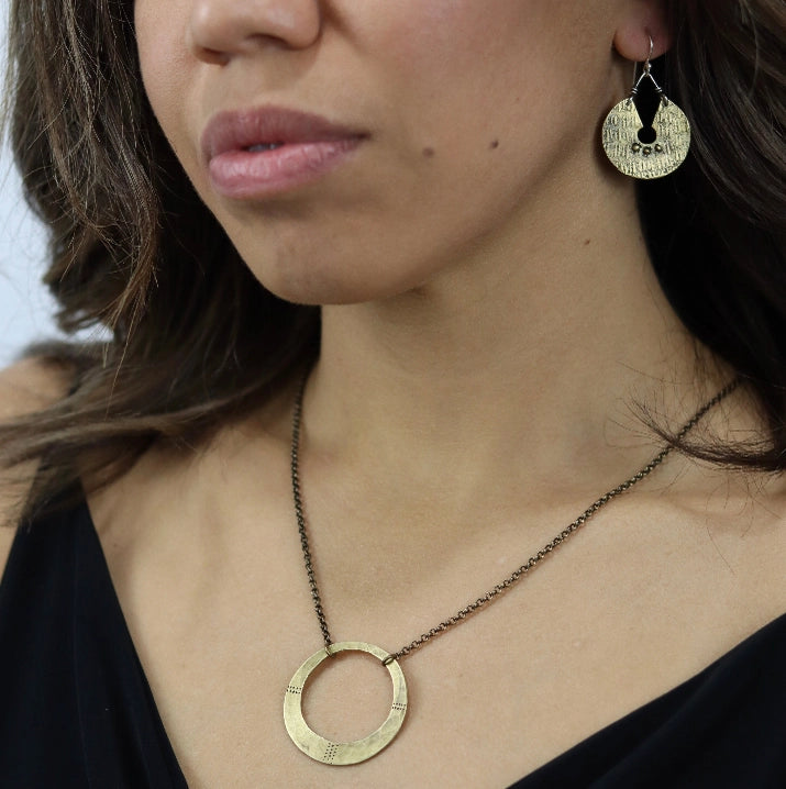 Woman wearing the Brass Textured Keyhole Discs 3 Dots Earrings by Jennifer Kahn Jewelry