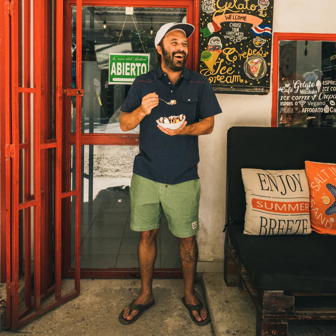 
                      
                        A man wearing the Lichen Green Pressure Drop Cord Short by Howler Bros
                      
                    