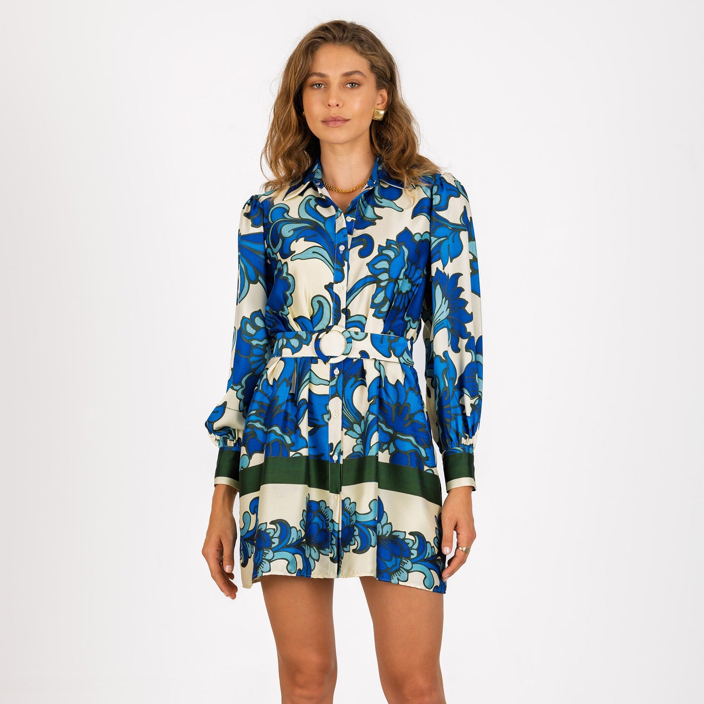 Woman wearing a blue and white floral dress with a collar neckline and mini length