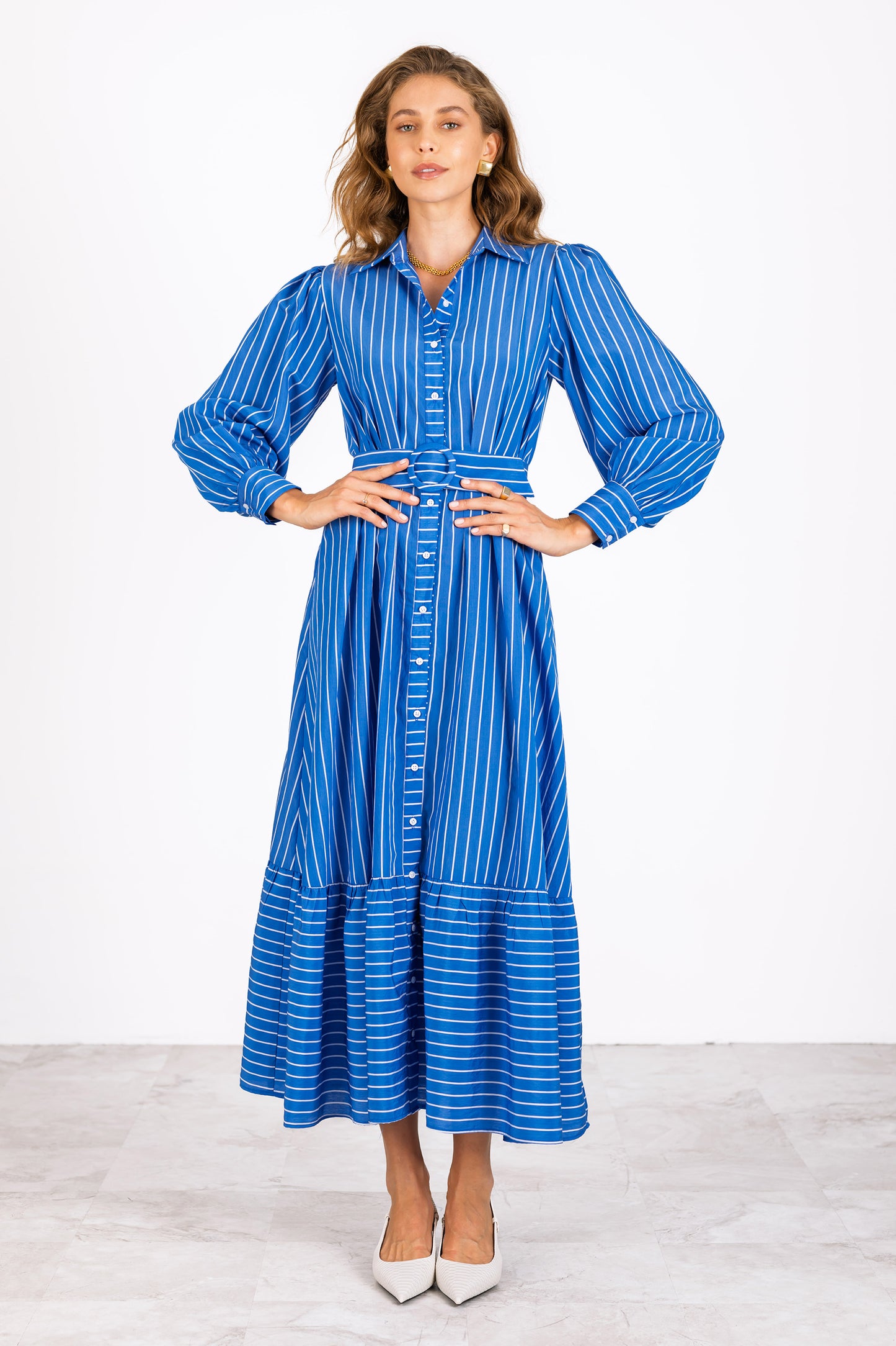 Woman wearing a blue and white striped long sleeve shirt dress by Lavender Brown