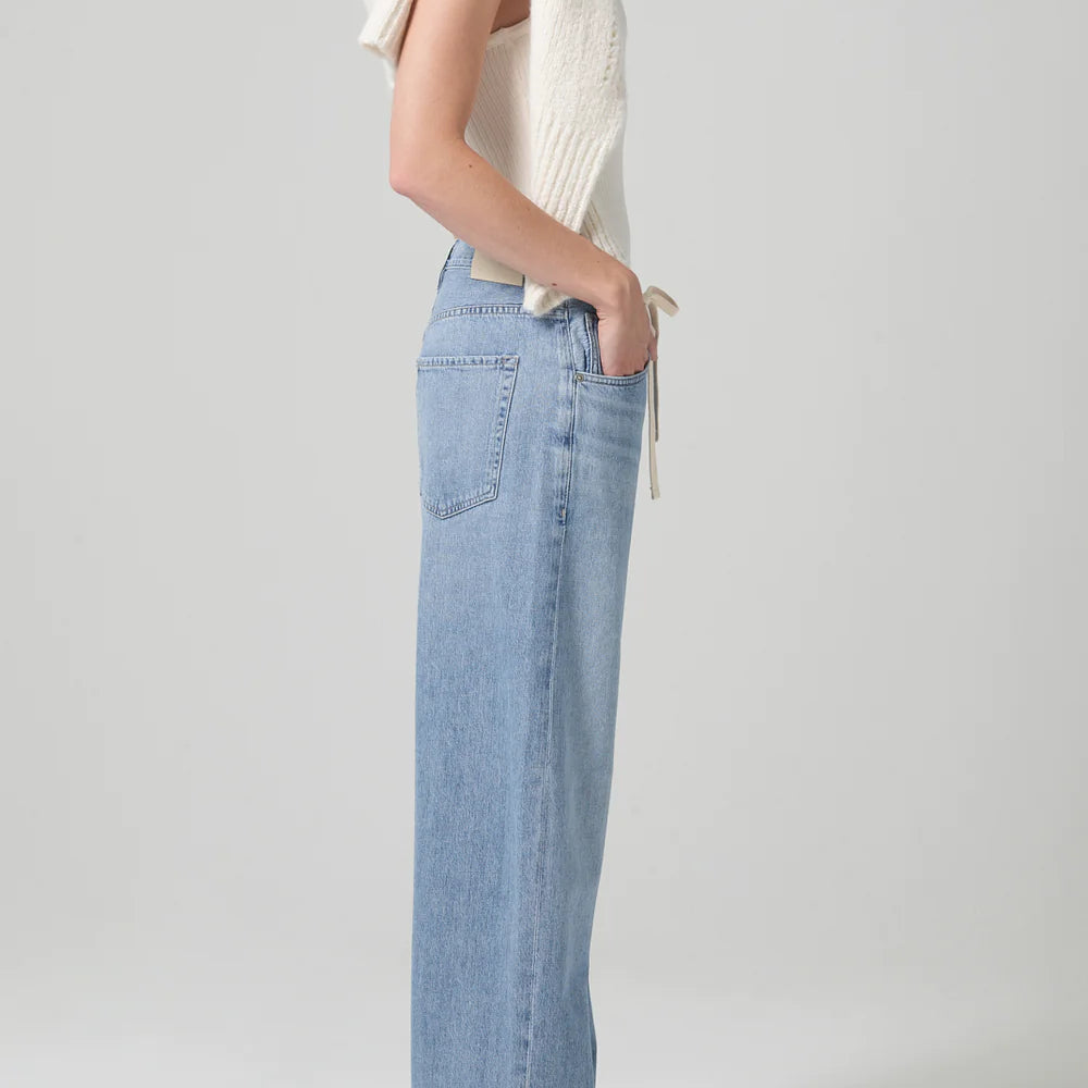 
                      
                        Side view of model wearing the light indigo Brynn Drawstring Trouser by Citizens of Humanity
                      
                    