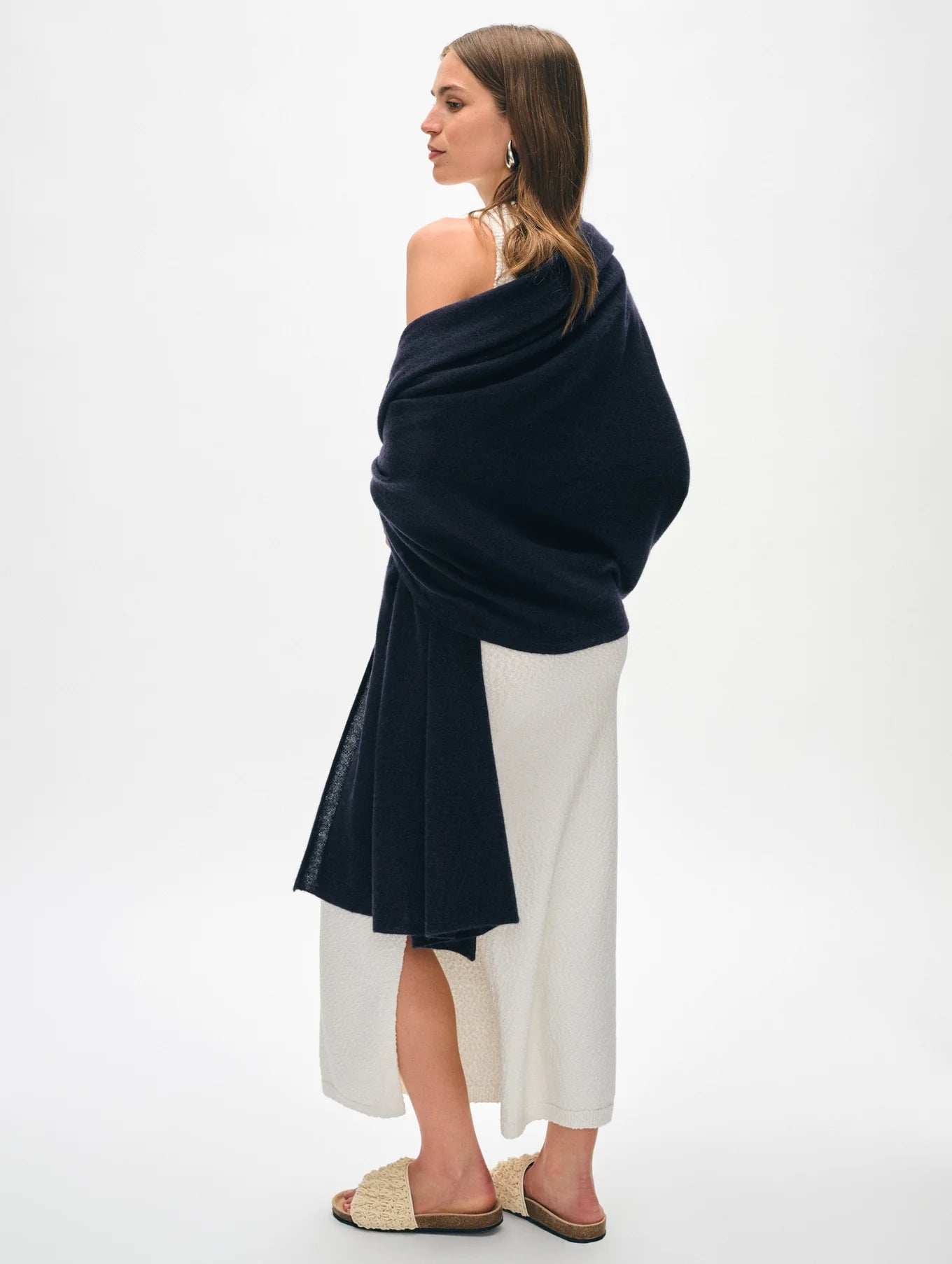 Back view of a woman wearing the Deep Navy Cashmere Travel Wrap by White + Warren