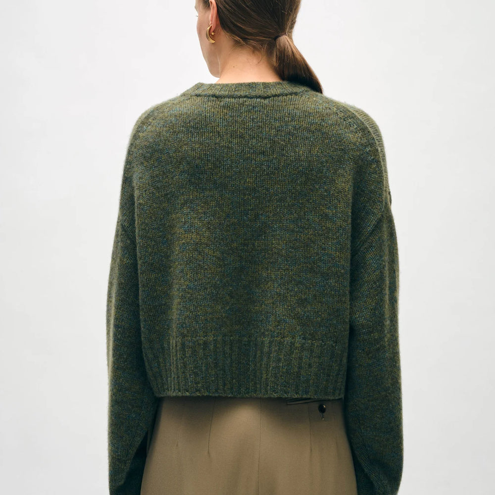
                      
                        Back view of a woman wearing the Cashmere Luxe Crewneck in the color Green Marl by the brand White + Warren
                      
                    