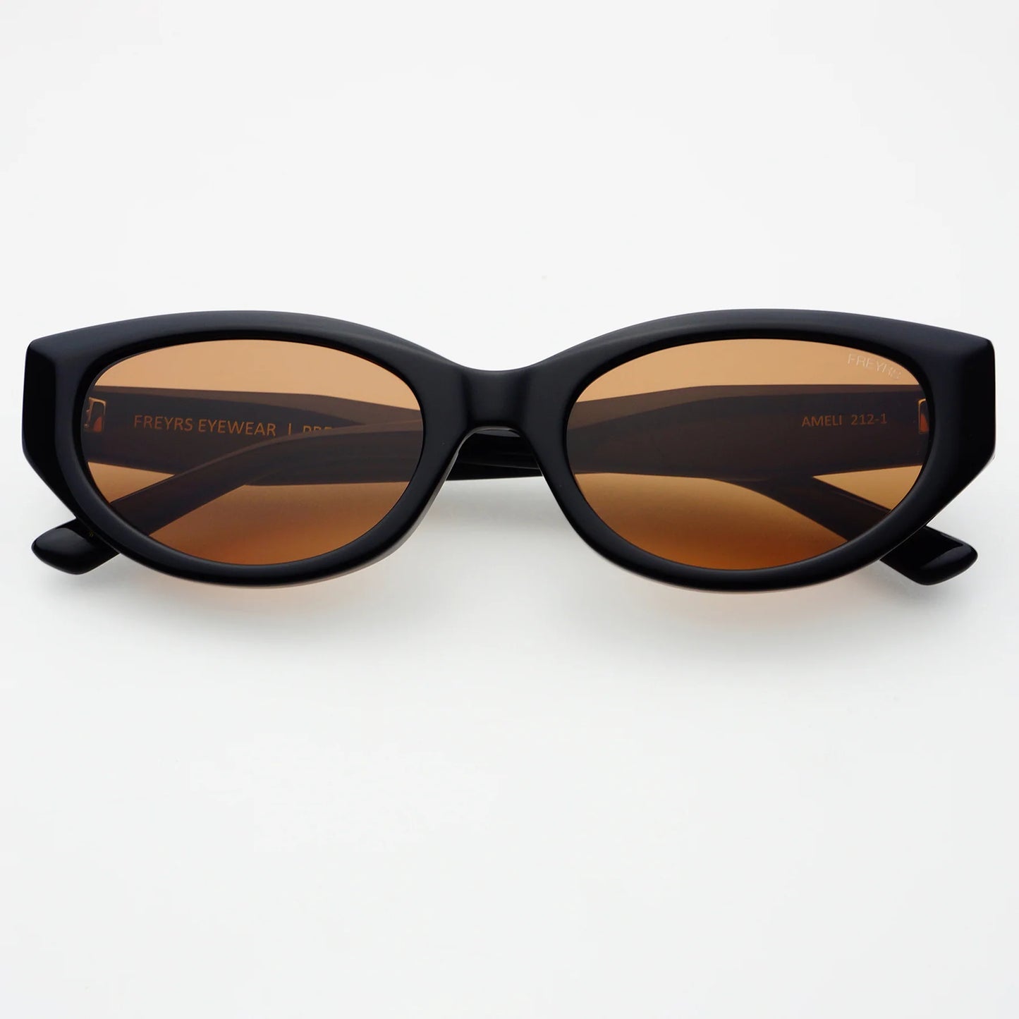 Black sunglasses with brown lenses on a white background