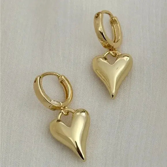 The Tramps + Thieves Lovefull Heart Huggies are 925 sterling silver gold vermeil plated huggie hoops featuring abstract heart charms, and are available to shop at Harbour Thread 