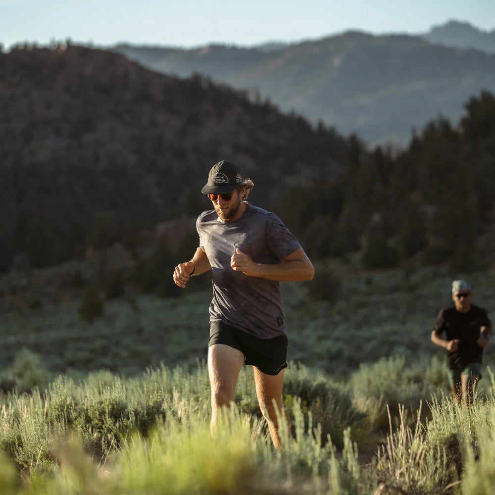 
                      
                        Man running outside while wearing the Mathis Grey Tie Dye Short Sleeve Tee by Roark,
                      
                    