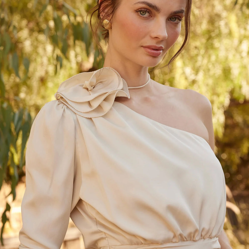 Outdoor lifestyle photo of woman wearing the champagne color Carmelita Satin Corsage Top by ASTR