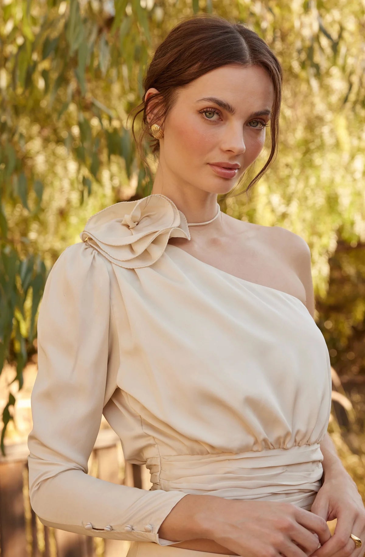 Outdoor lifestyle photo of woman wearing the champagne color Carmelita Satin Corsage Top by ASTR