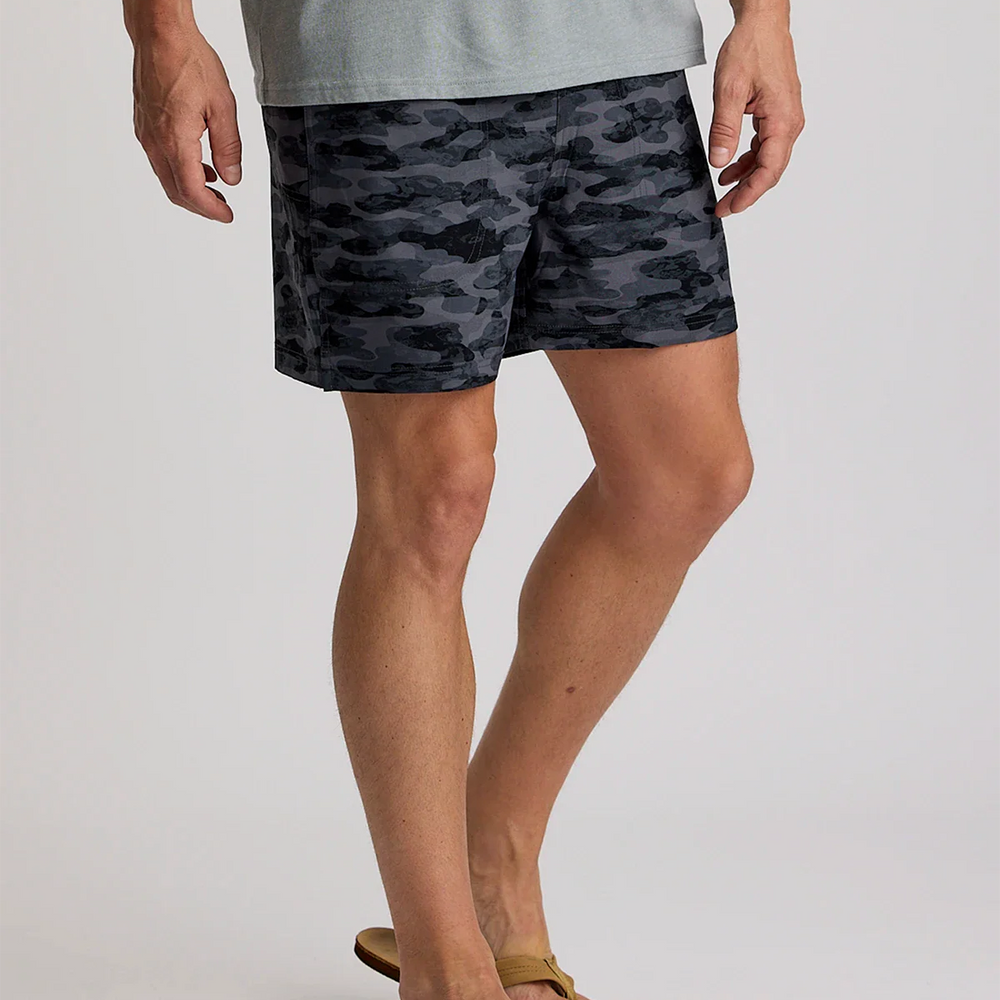 
                      
                        A man wearing the wearing the Free Fly Men's 5.5" Bamboo-Lined Active Breeze Shorts in the color Seasmoke Camo Black
                      
                    