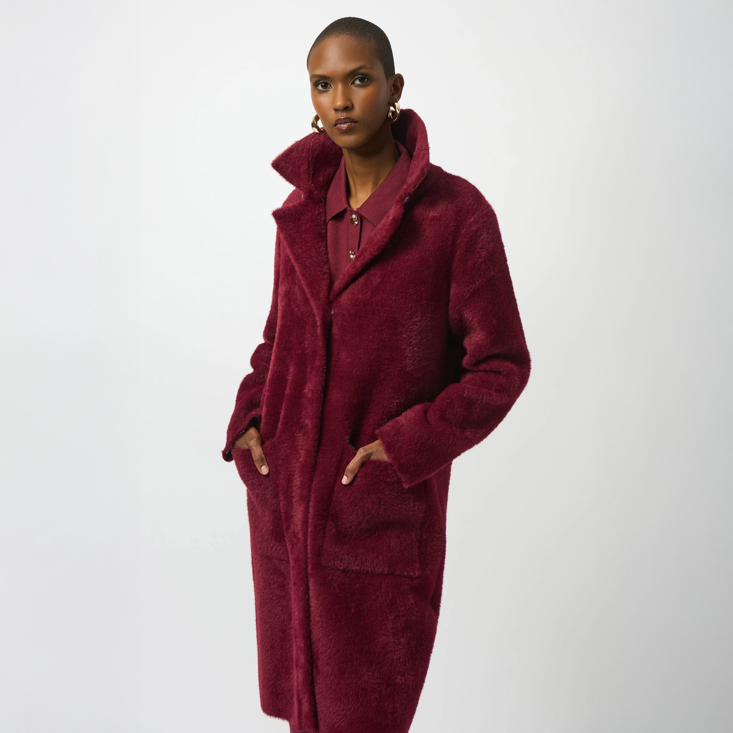 Woman wearing a burgundy coat with pockets