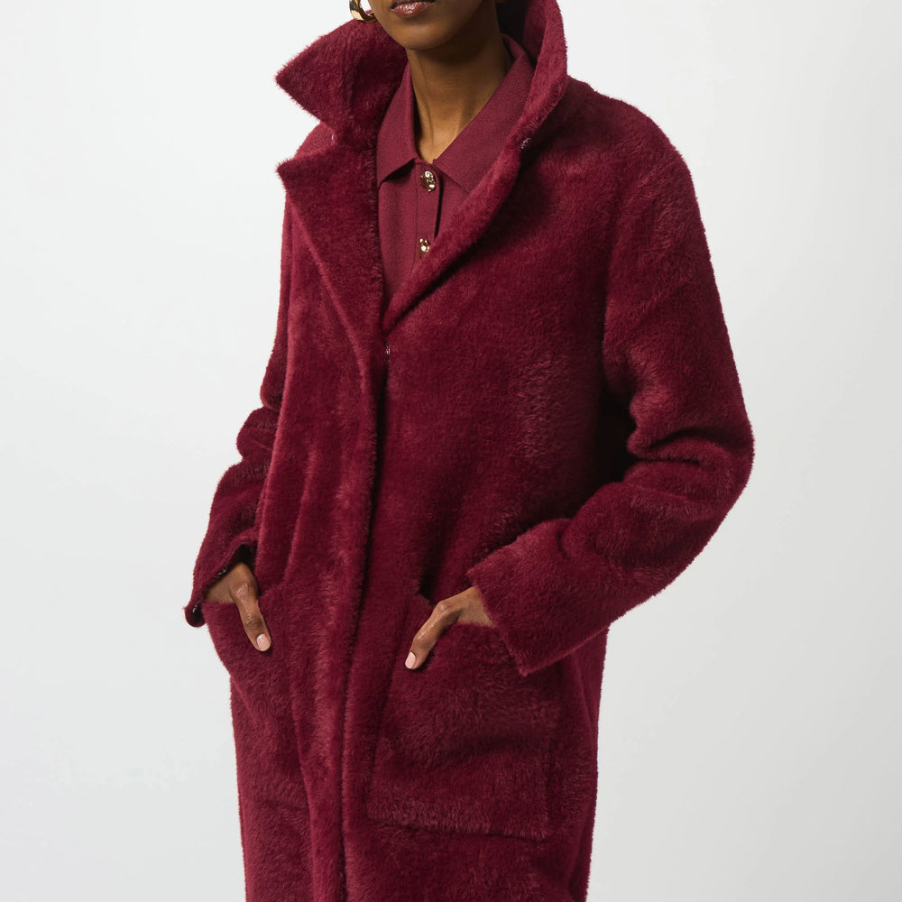 
                      
                        Woman wearing a burgundy coat with pockets
                      
                    