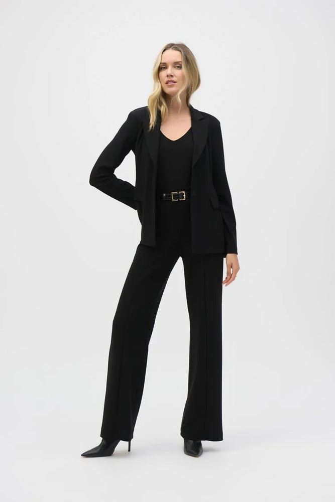 A woman wearing an all black outfit consisting of a top, blazer and the Silky Knit Belted Wide-Leg Pants from Joseph Ribkoff