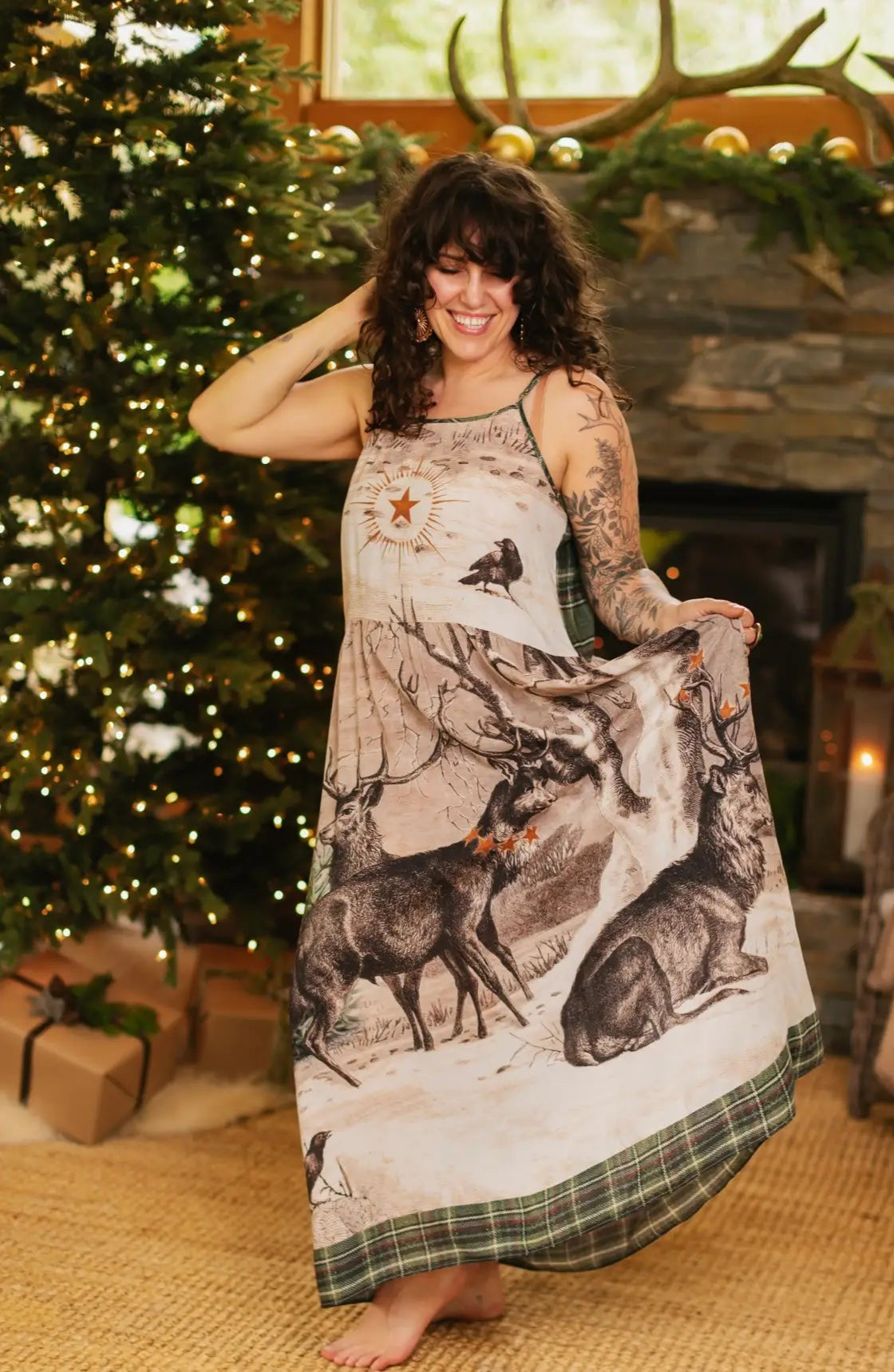 Woman wearing a long dress with nature-themed print in a festive indoor setting.