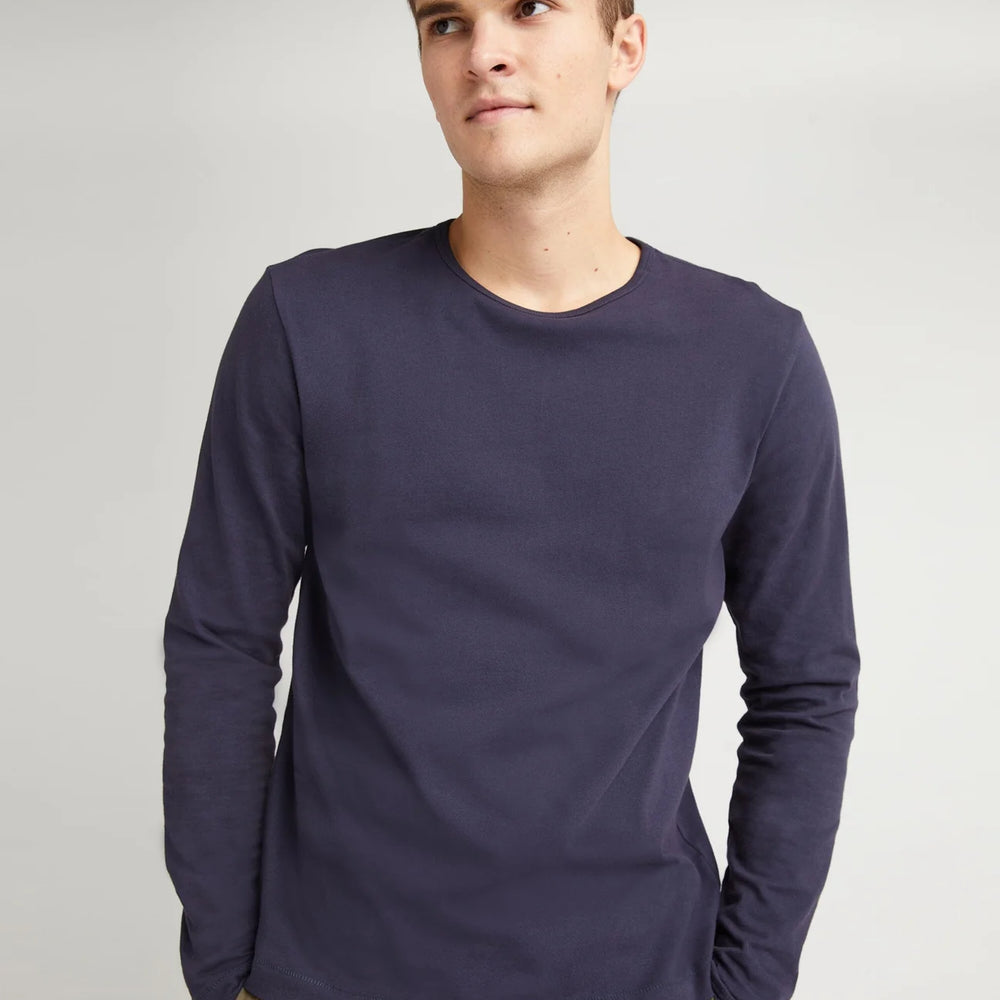 
                      
                        A man wearing the Weighted Organic Cotton Long Sleeve Tee by Richer Poorer in the color Blue Steel
                      
                    