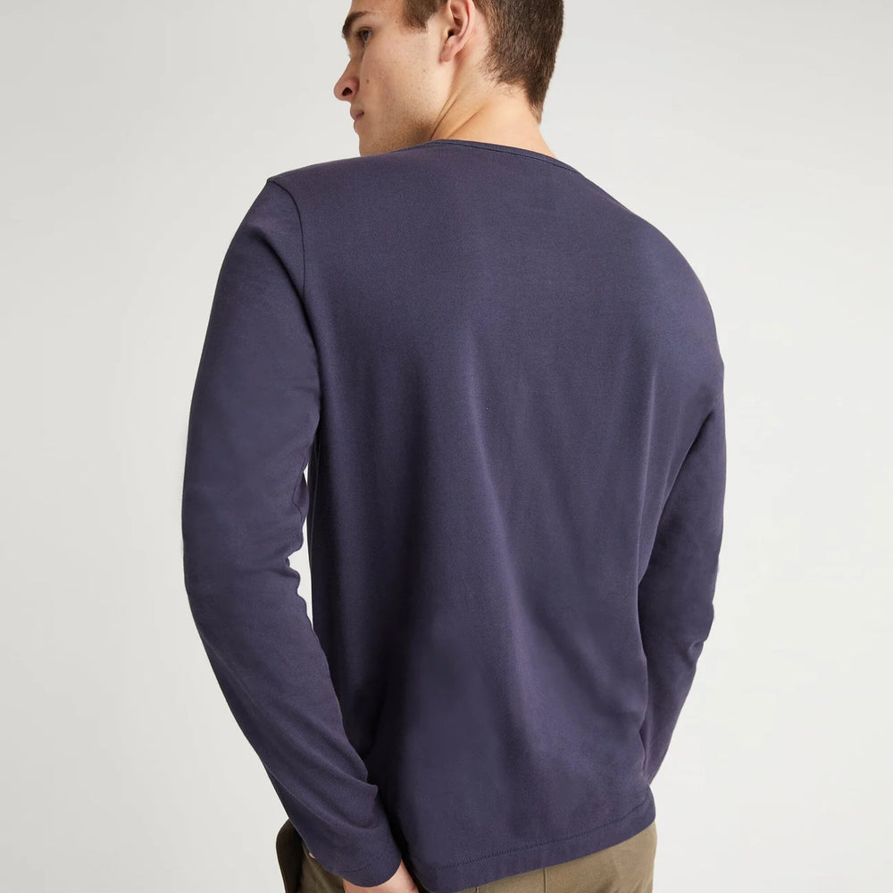 
                      
                        Back view of a man wearing the Weighted Organic Cotton Long Sleeve Tee by Richer Poorer in the color Blue Steel
                      
                    