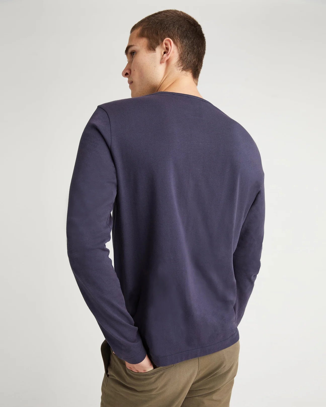 back view of model wearing a long sleeve blue color t-shirt