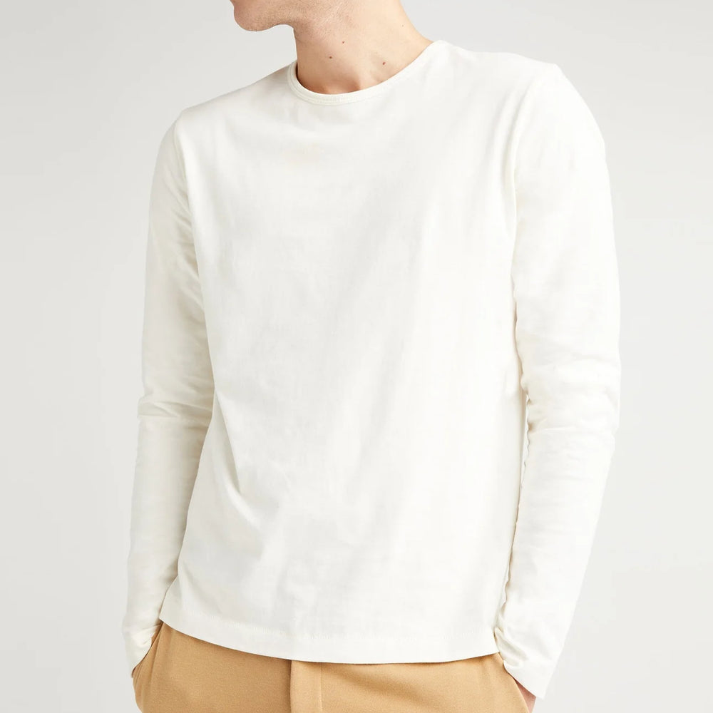 
                      
                        A man wearing the Weighted Organic Cotton Long Sleeve Tee by Richer Poorer in the color Bone
                      
                    