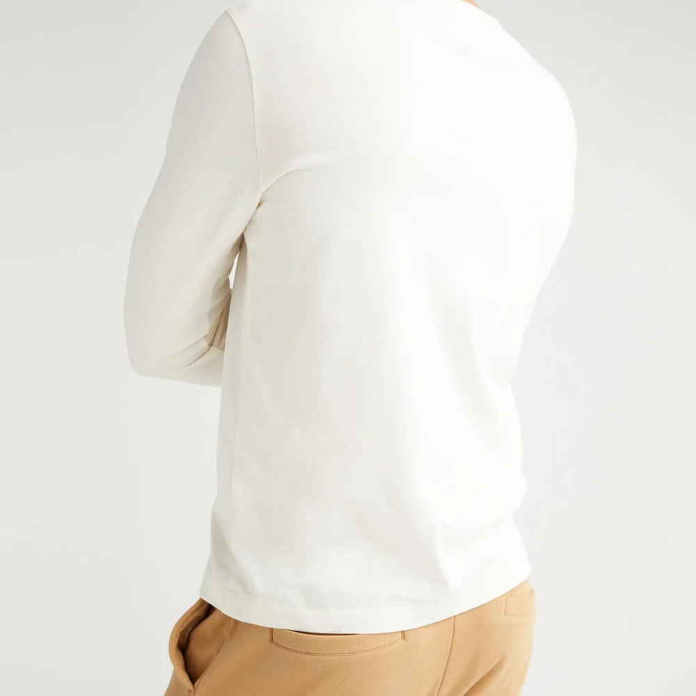 
                      
                        Back view of a man wearing the Weighted Organic Cotton Long Sleeve Tee by Richer Poorer in the color Bone
                      
                    