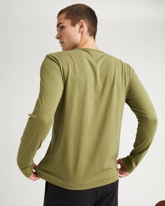 back view of model wearing a long sleeve green t-shirt