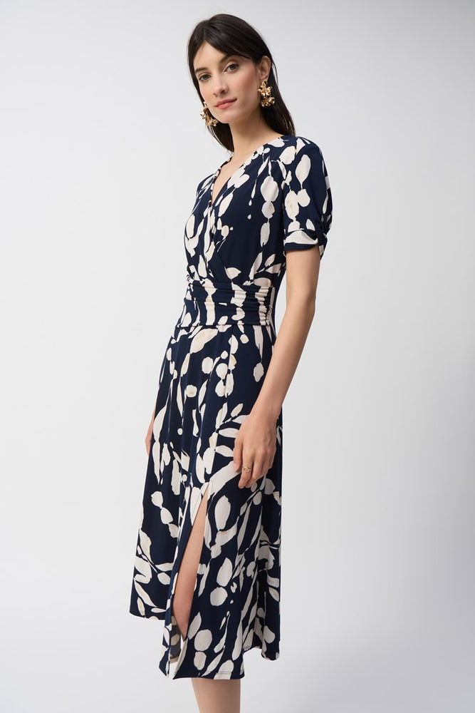 
                      
                        The Silky Knit Abstract Print Wrap Dress from Joseph Ribkoff features short sleeves and a side slit
                      
                    