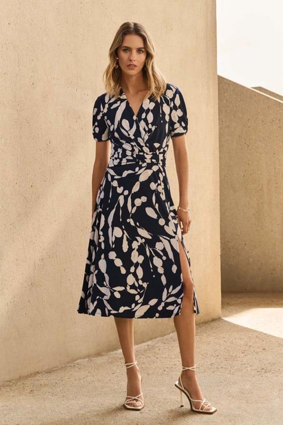 Tailored in a luxurious silky knit fabric, this flowy dress features a striking abstract print on a flattering fit and flare silhouette.