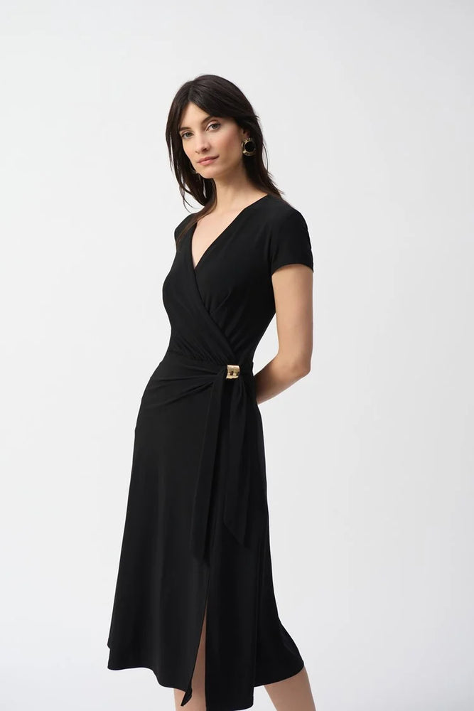 With a flattering wrap neckline and feminine cap sleeves, this flared midi dress offers shirring at the waist with a tie and ornament detail.