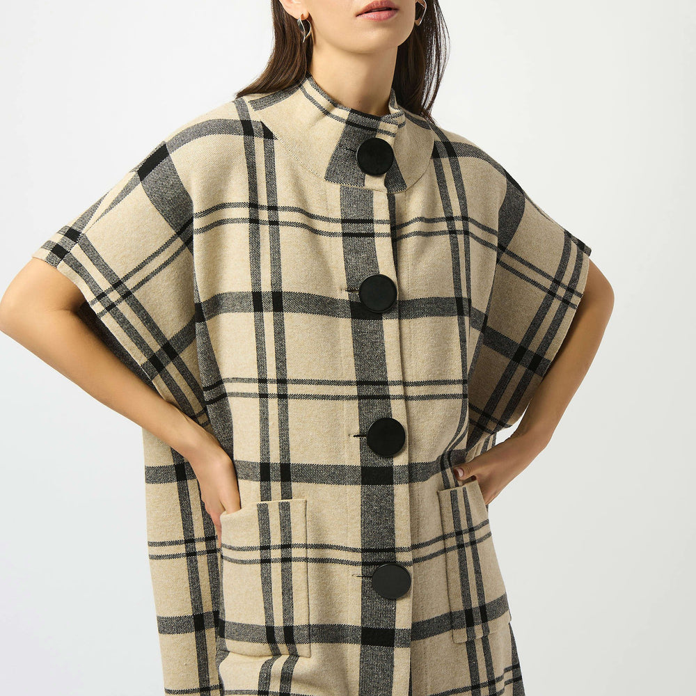 Crafted from a soft and cozy sweater knit, this plaid poncho from Joseph Ribkoff will elevate any cold-weather look. Now at Harbour Thread in Burlington, VT.