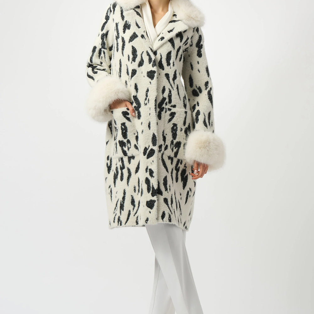 The Joseph Ribkoff Feather Yarn Animal Jacquard Coat with Faux Fur Trim is available at Harbour Thread boutique in Burlington, VT.