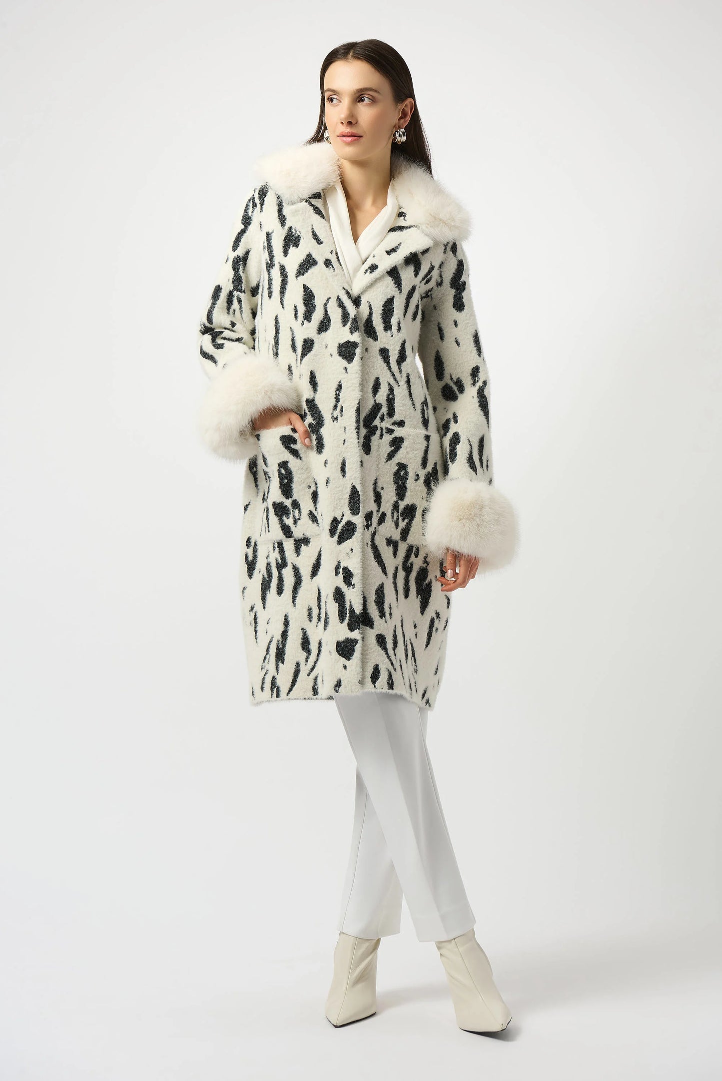 The Joseph Ribkoff Feather Yarn Animal Jacquard Coat with Faux Fur Trim is available at Harbour Thread boutique in Burlington, VT.