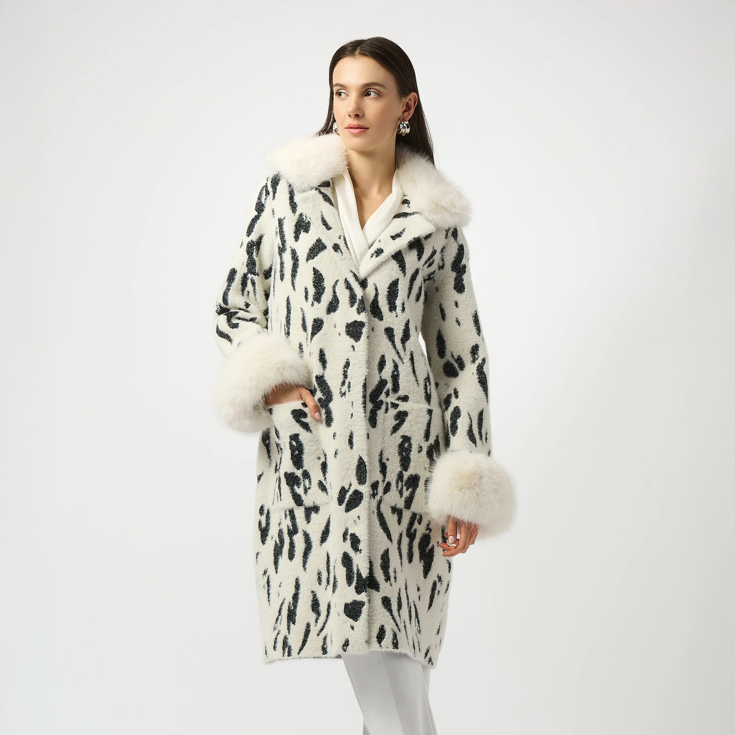 Woman wearing the Joseph Ribkoff Feather Yarn Animal Jacquard Coat with Faux Fur Trim.