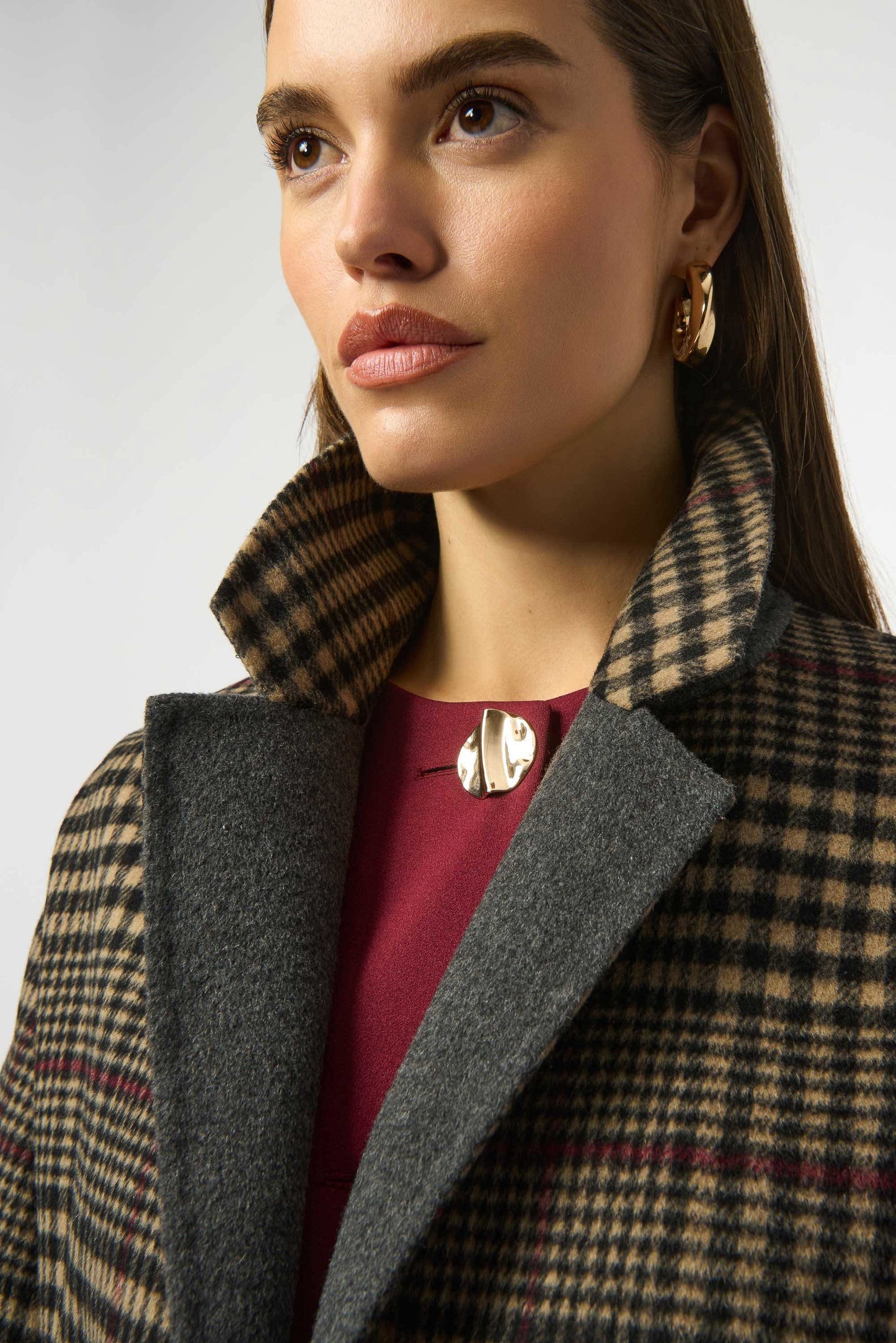 Close up of a woman wearing the Wool Blend Plaid Double-Faced Coat from Joseph Ribkoff to feature the notched collar