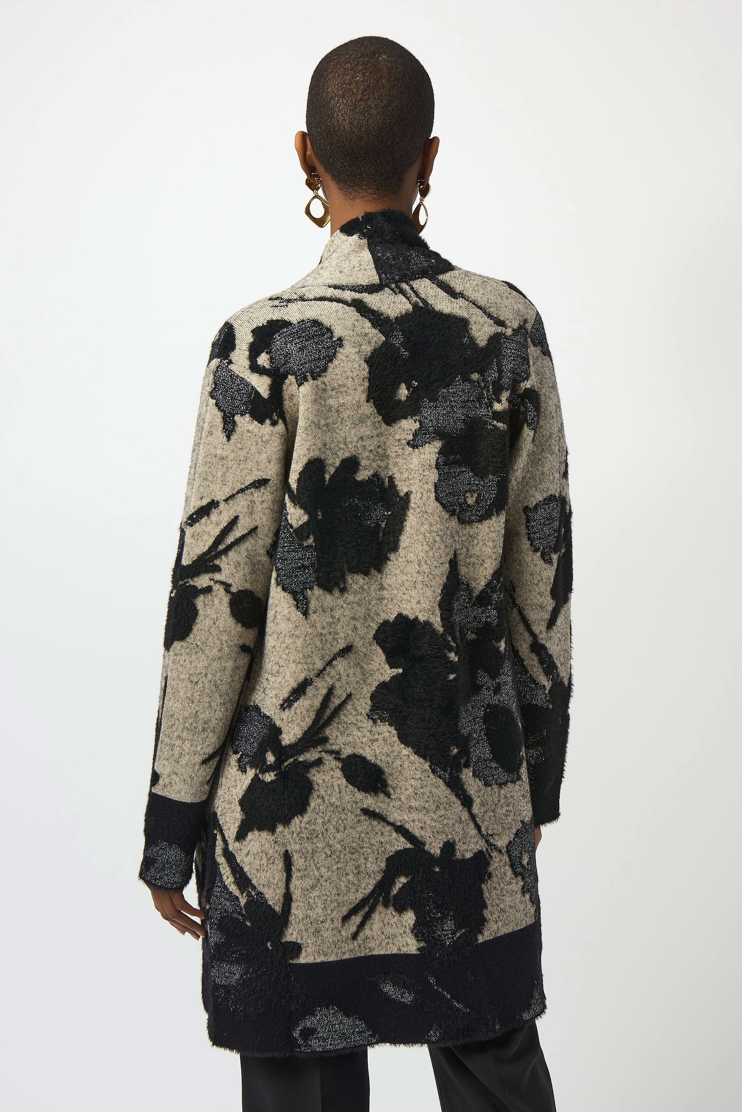 Person wearing a floral patterned cardigan from Joseph Ribkoff