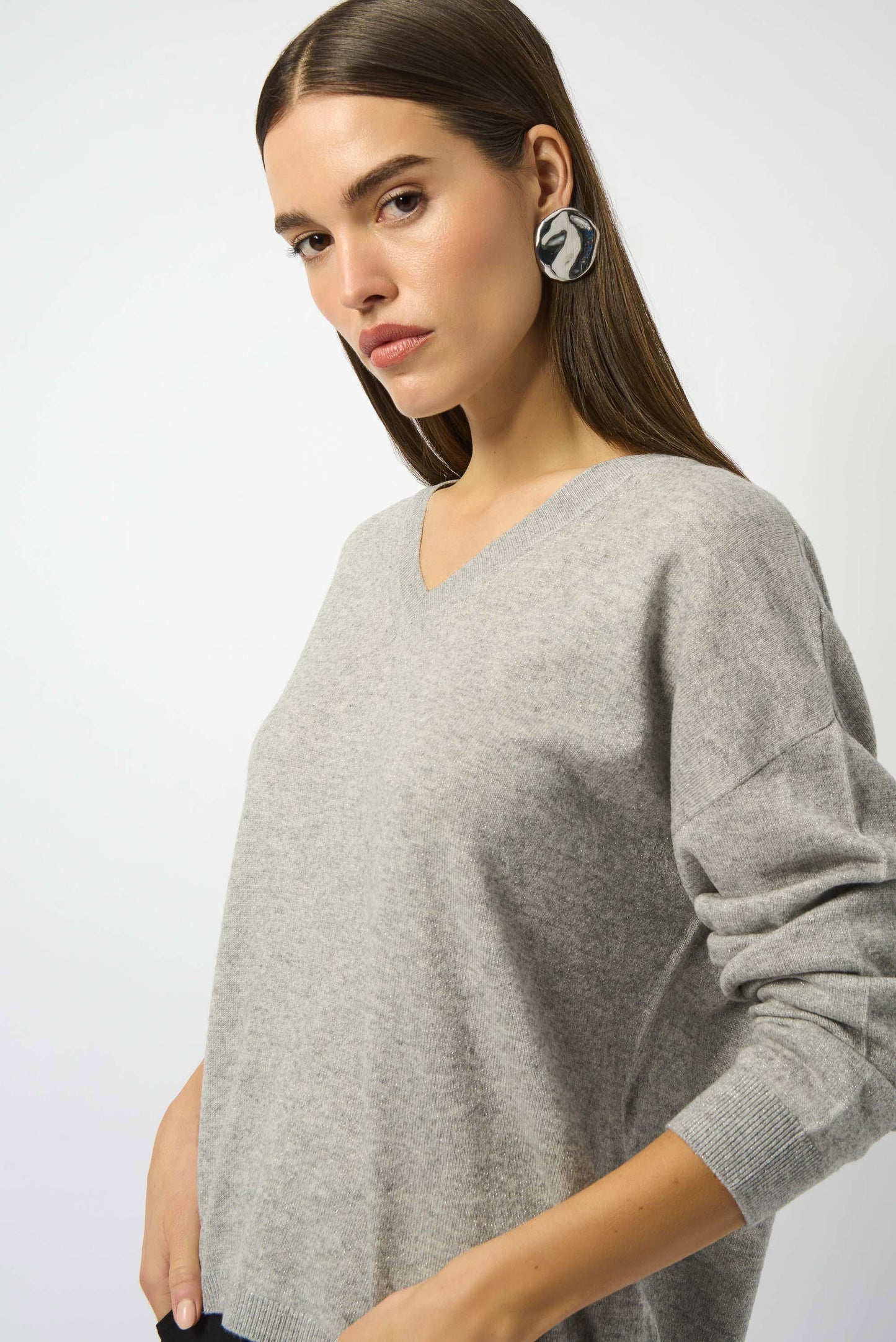 A woman wearing the Joseph Ribkoff Wool Blend V-Neck Boxy Sweater in Light Grey