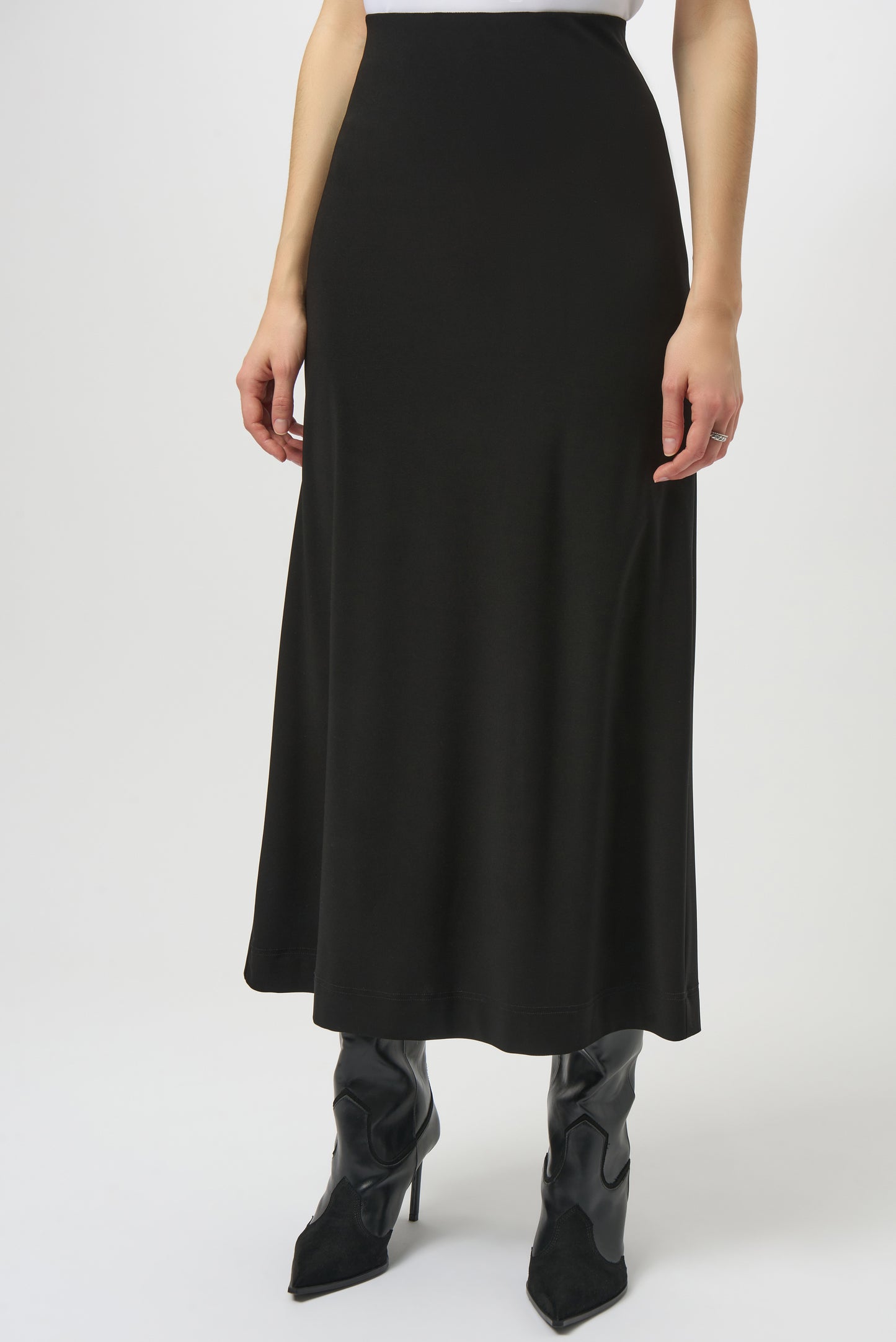A woman wearing a black maxi skirt with black boots
